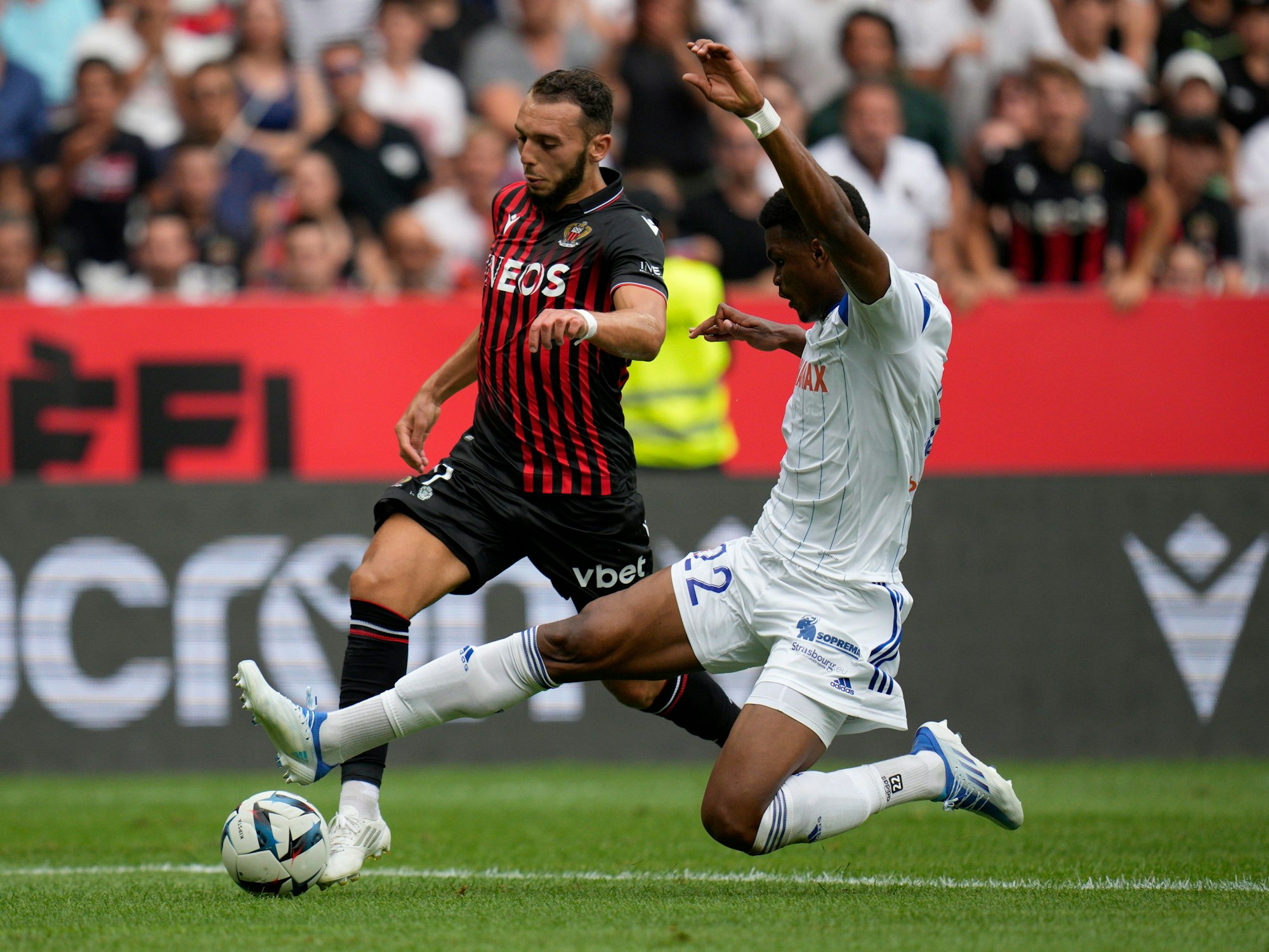 Nizzas Amine Gouiri (l) wird von Straßburgs Gerzino Nyamsi (r) per Grätsche gestört.