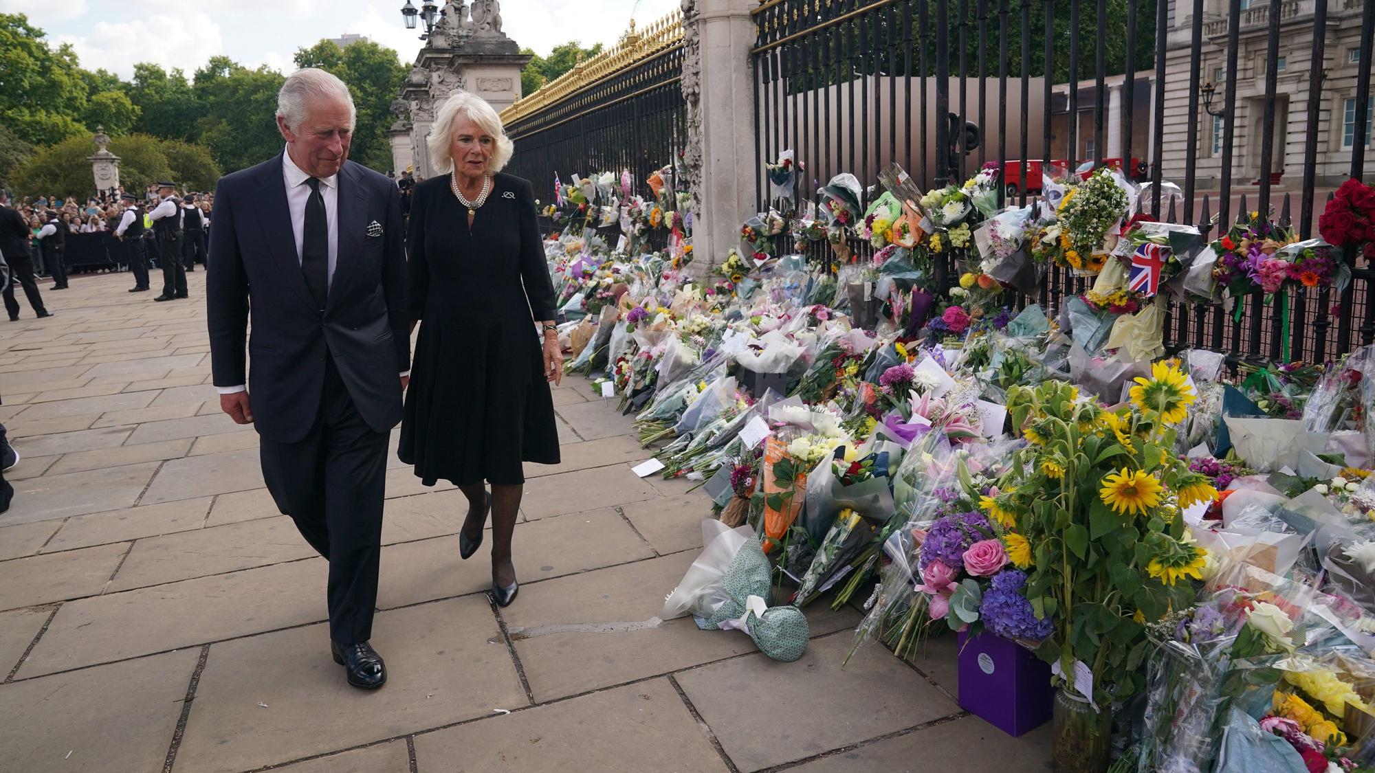 König Charles III. und seine Frau Camilla sehen sich die Blumengestecke und persönlichen Grußworte an, die nach dem Tod von Königin Elizabeth II. vor dem Buckingham-Palast abgelegt wurden.