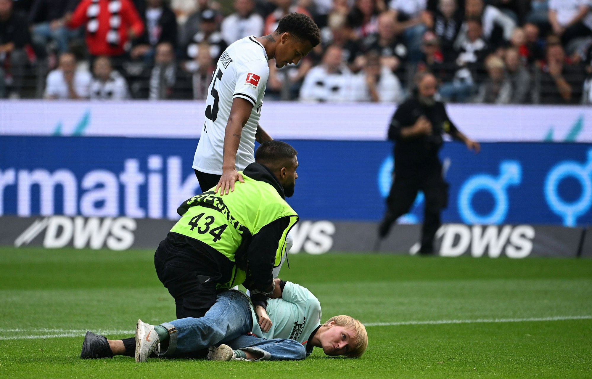 Ein Aktivist wird von einem Ordner auf dem Boden festgehalten