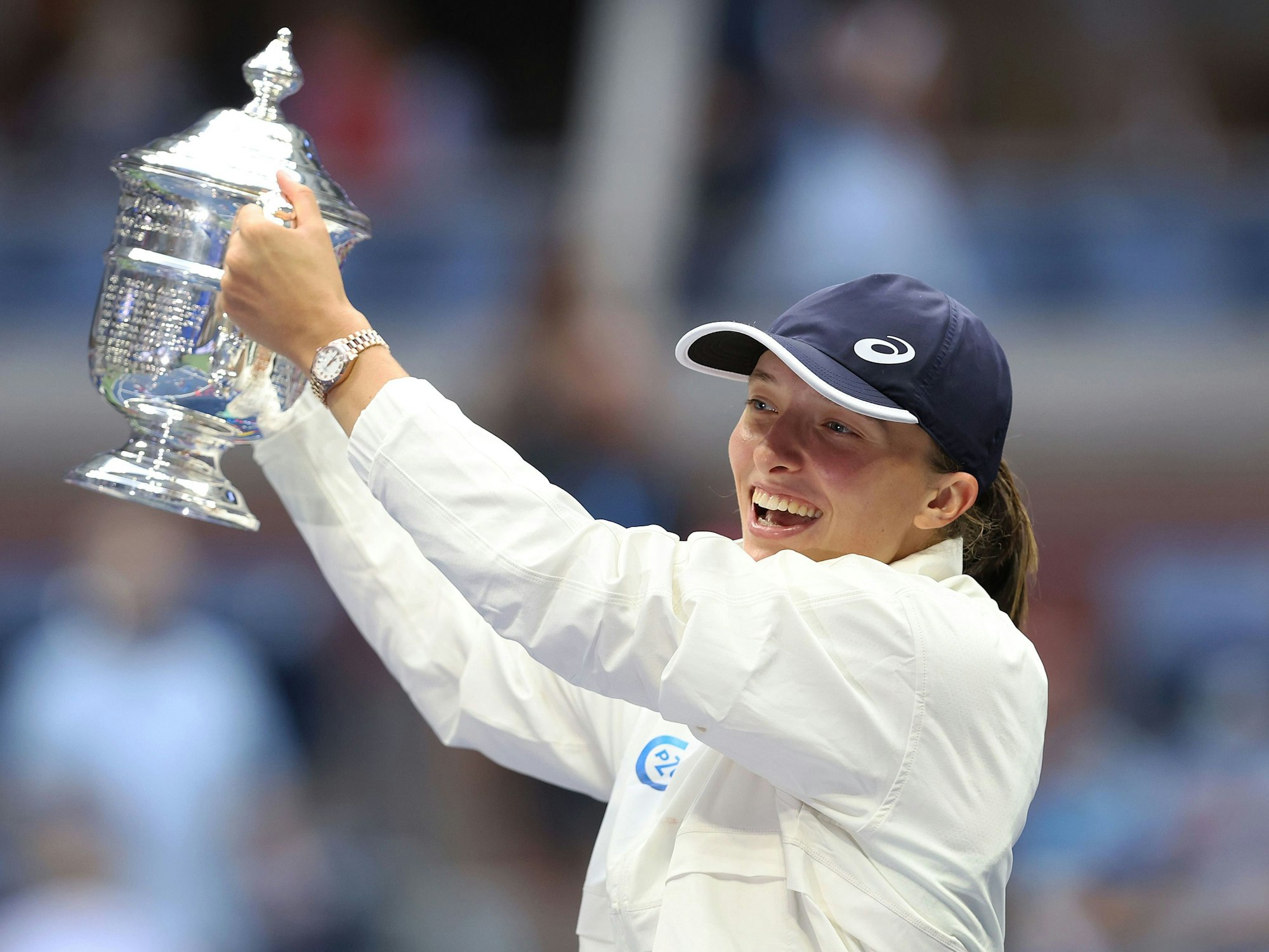Iga Swiatek hebt die Trophäe nach dem Sieg bei den US Open in die Höhe.