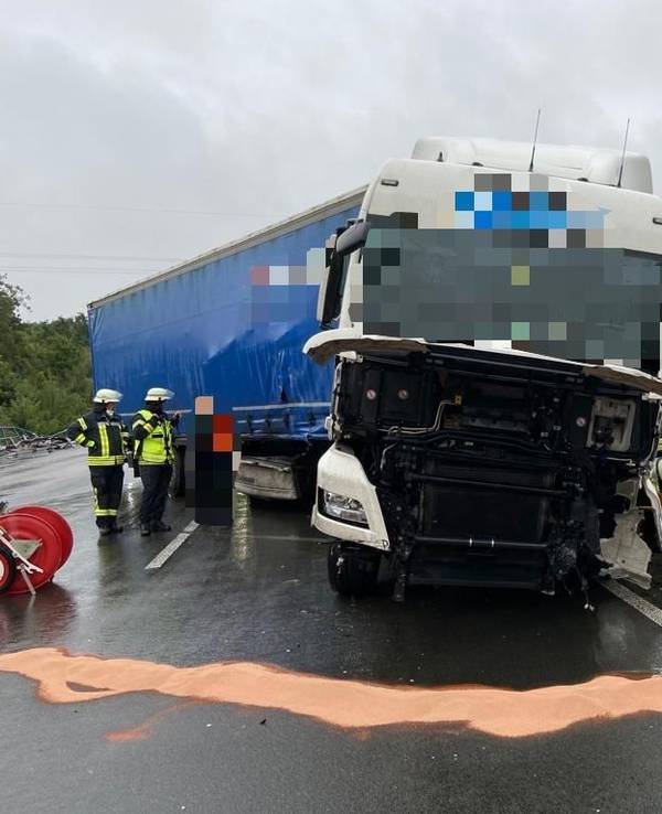 Beschädigter Lkw steht nach einem Unfall auf der Autobahn und wird von Einsatzkräften bearbeitet.