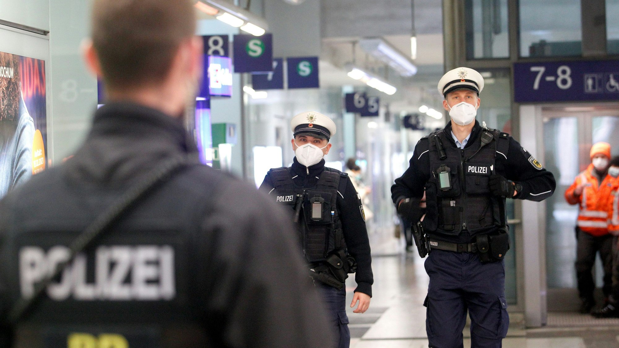 Beamte der Bundespolizei laufen im Bahnhofsgebäude Streife.