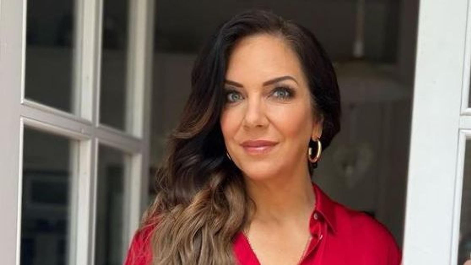 Danni Büchner posiert in einem roten Oberteil für die Kamera.