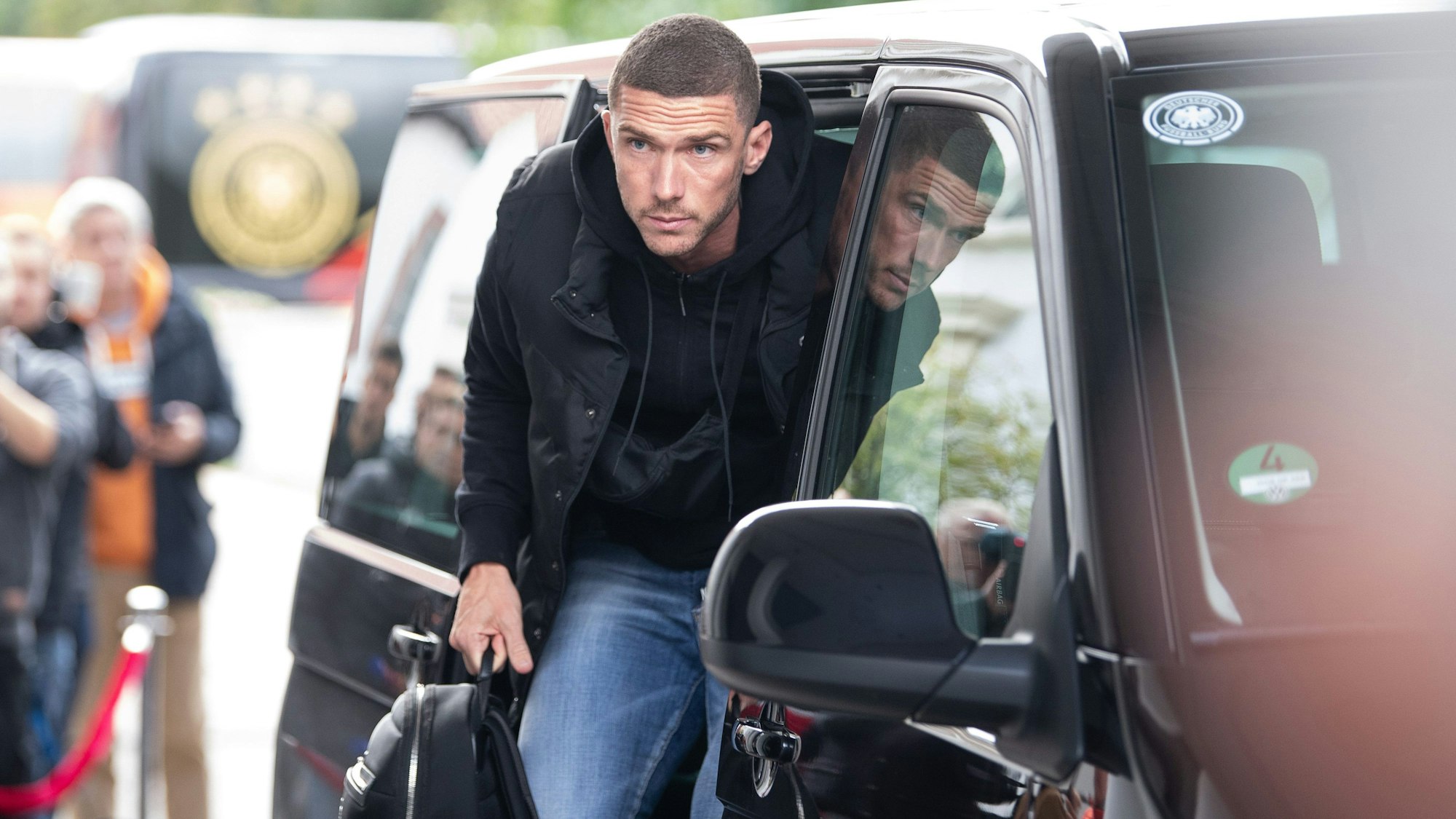 Robin Gosens steigt aus einem Auto aus.