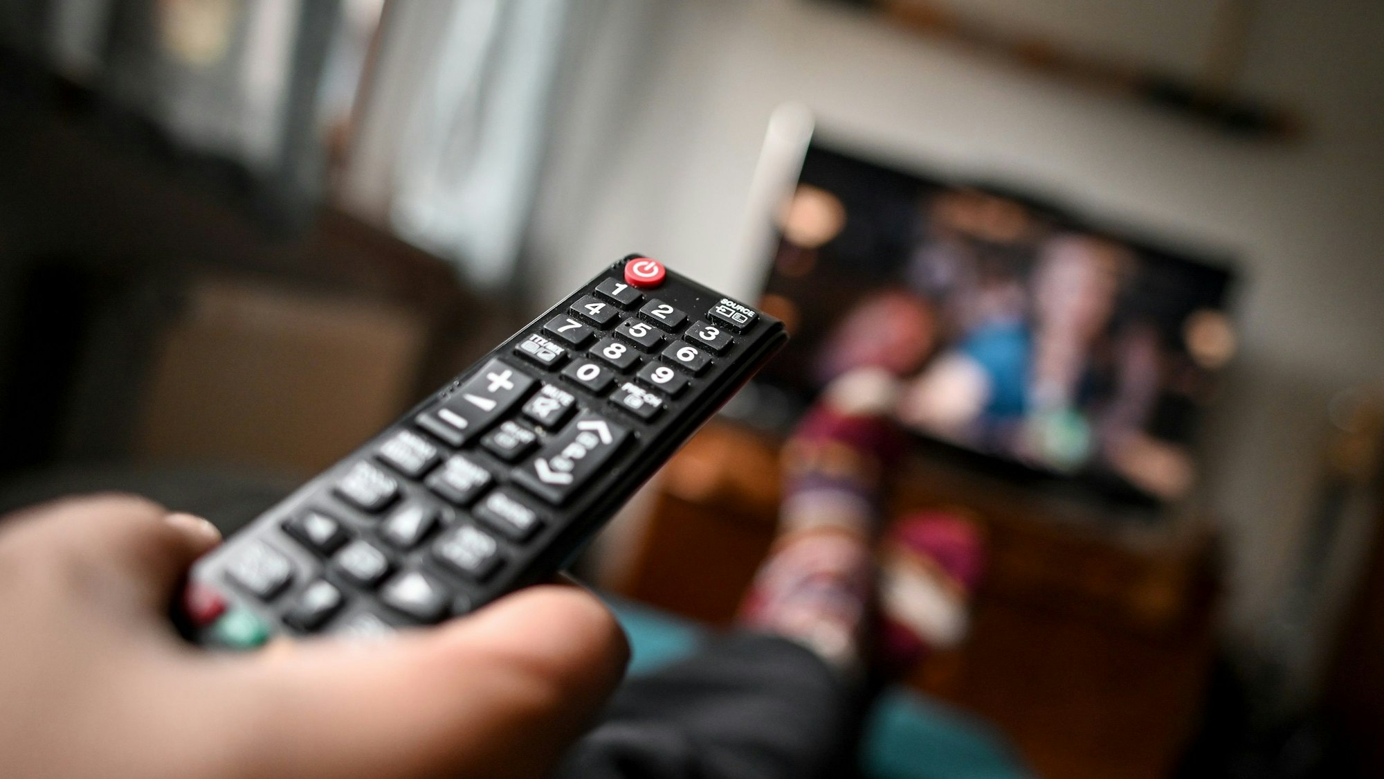 ProSieben ändert ab Sonntag (25. September) sein Abendprogramm. Unser Symbolbild zeigt einen jungen Mann mit einer Fernbedienung.