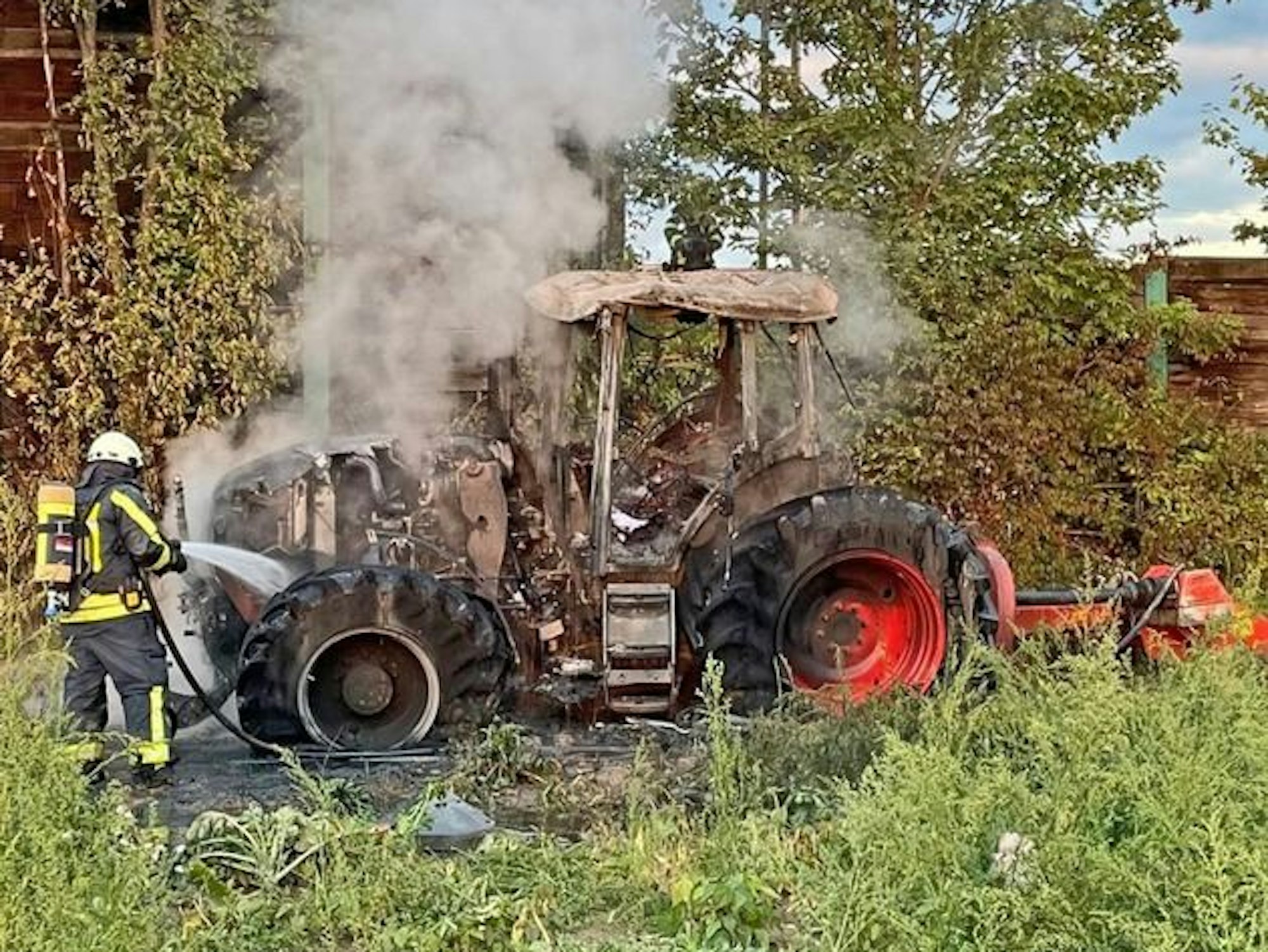 Der vom Feuer zerstörte Traktor auf dem Feld