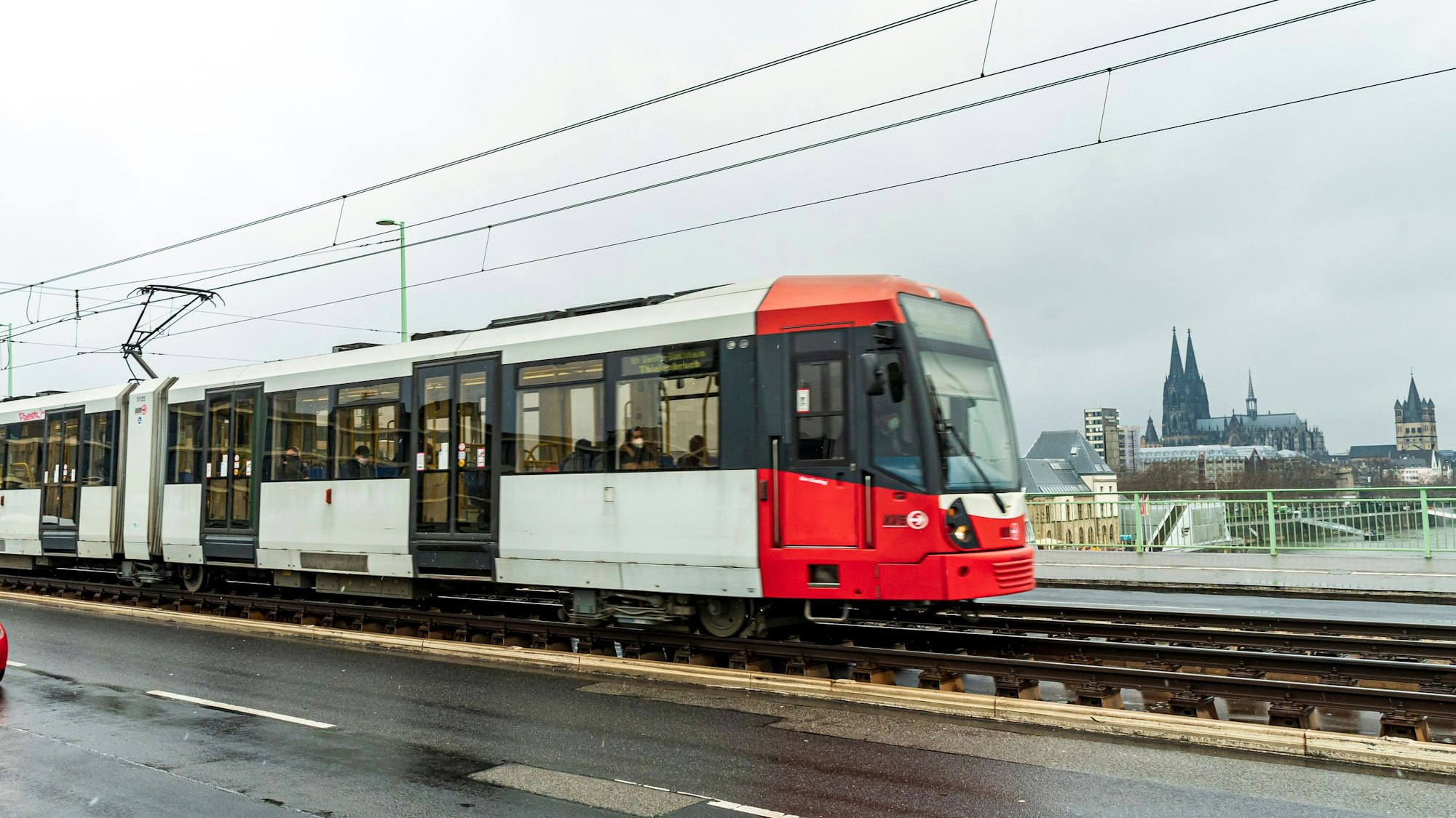 Ein Einzelzug der KVB-Straßenbahnlinie 3 fährt über die Severinsbrücke in Köln. Im Hintergrund ist der Dom zu sehen.