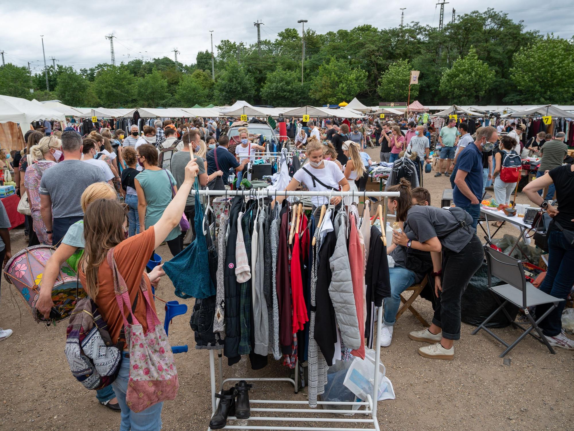 Menschen gehen über den Flohmarkt am Kölner Südstadion.