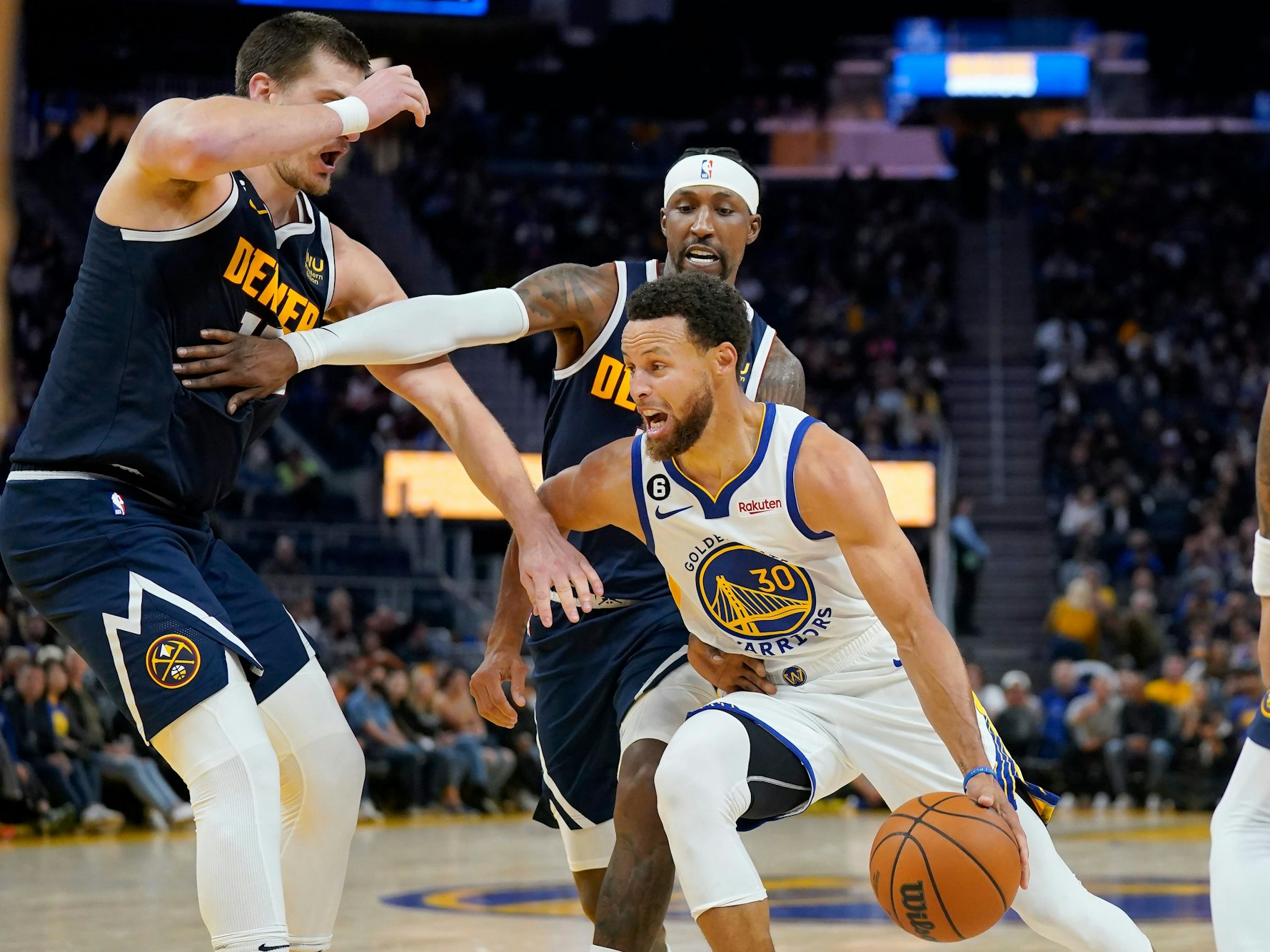Stephen Curry (r.) im Duell mit Kentavious Caldwell-Pope (M.) und Nikola Jokic.