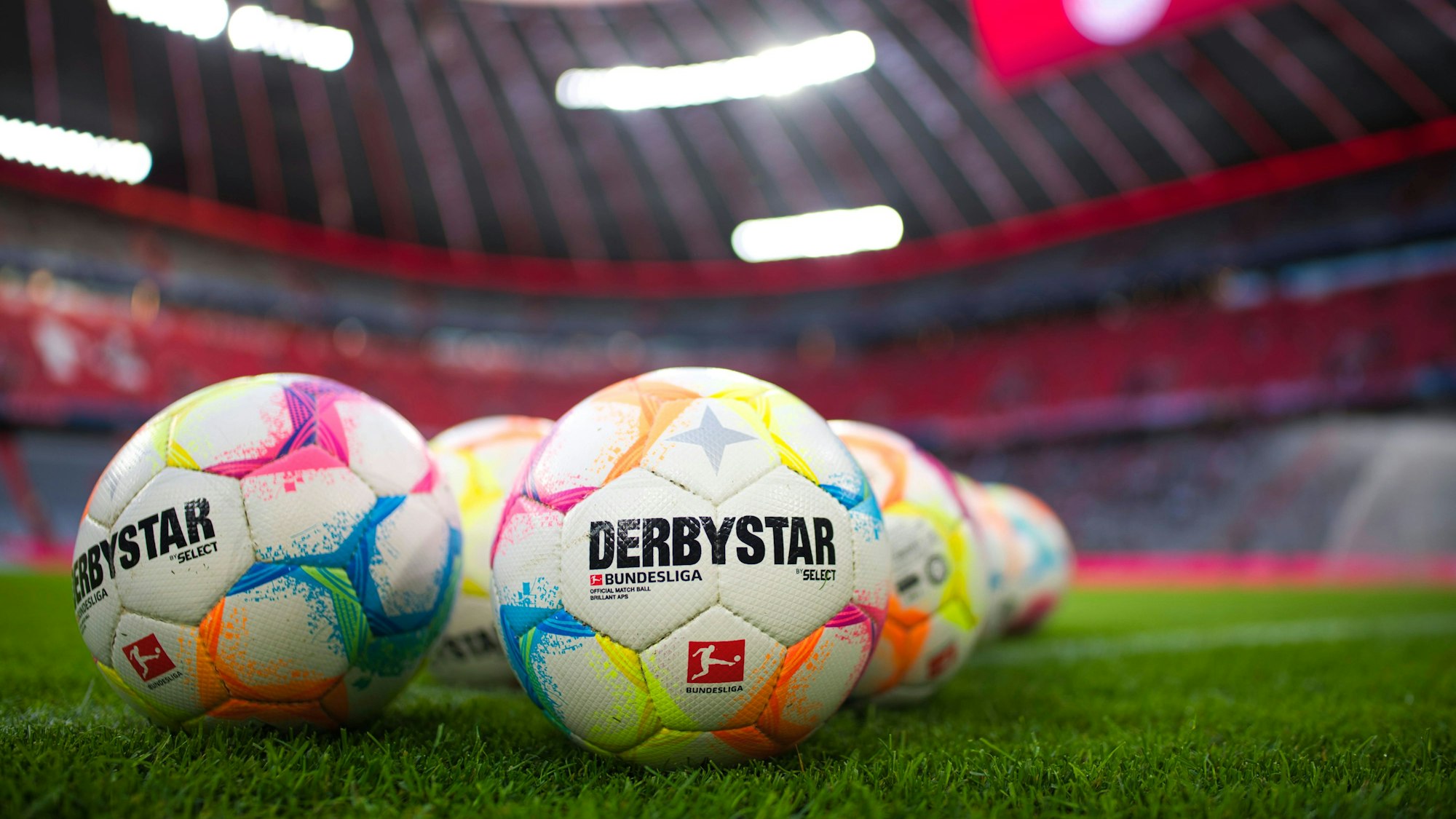 Fußbälle der Bundesliga auf dem Rasen.