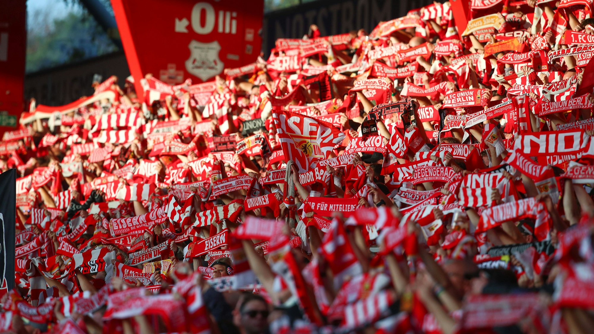 Zahlreiche Fans von Union Berlin halten ihre Schals in die Höhe.