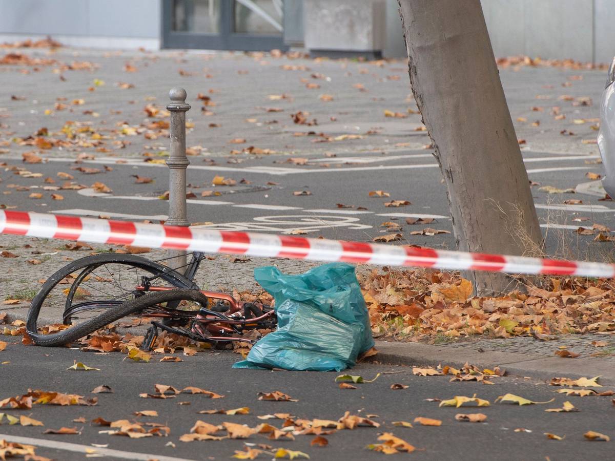 Ein zerstörtes Fahrrad liegt auf an einer Straße, die mit Flatterband der Polizei in dem Bereich abgesperrt wurde.