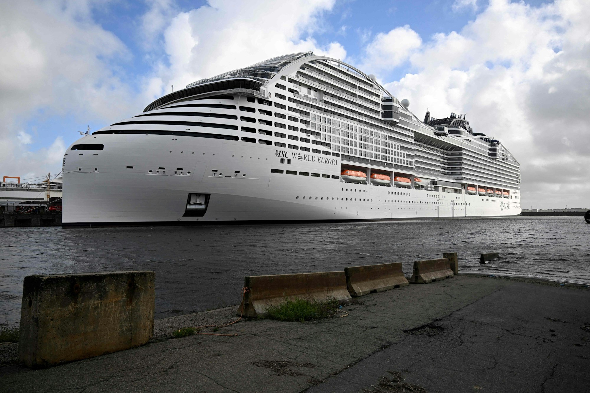 A picture taken on October 24, 2022 shows a view of the Ocean liner MSC World Europa during its delivery ceremony at Saint-Nazaire's harbour, western France. (Photo by DAMIEN MEYER / AFP)