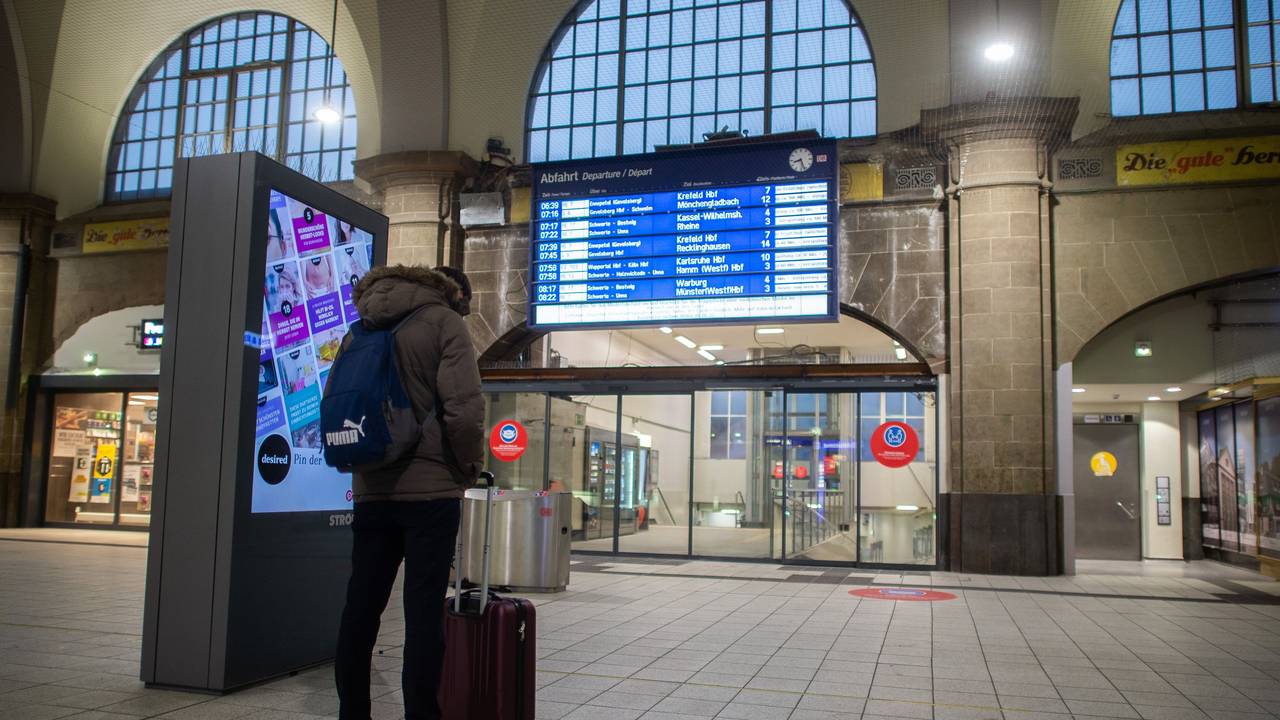 Ein Mann steht im Hagener Hauptbahnhof vor der Anzeigetafel.