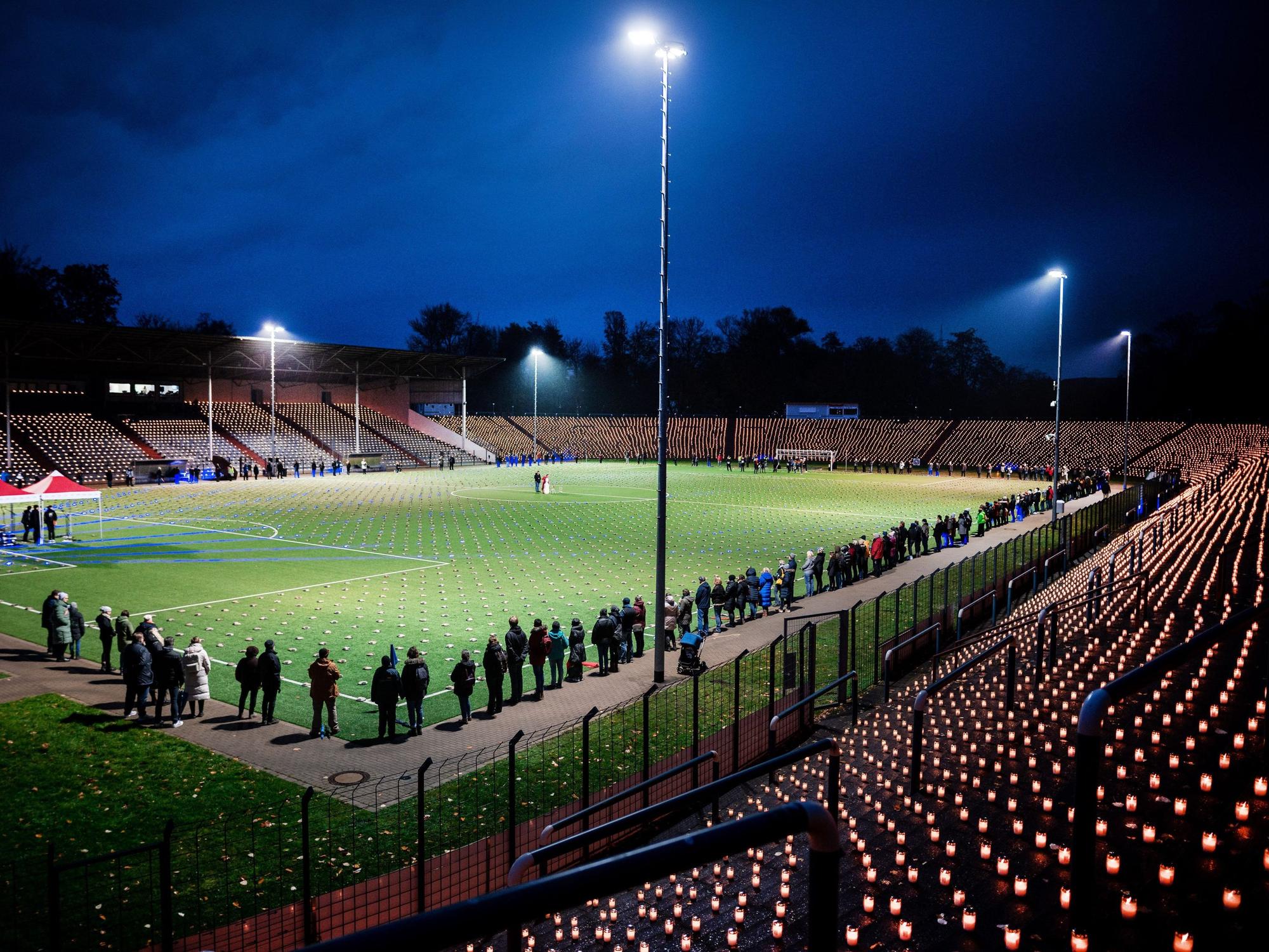 Hell erleuchtetes Stadion mit Flutlicht und 20.000 Kerzen. Die Aktion ist ein Protest gegen die Fußball-WM in Katar.