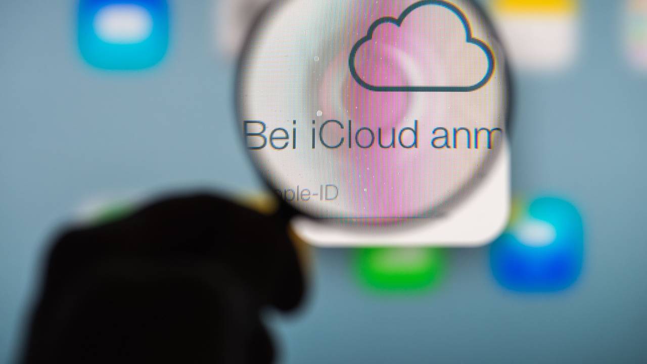 Eine Hand hält am 13.01.2014 in Straubing (Bayern) ein Vergrößerungsglas vor die Internetseite des Online-Speicherdienstes iCloud von Apple.