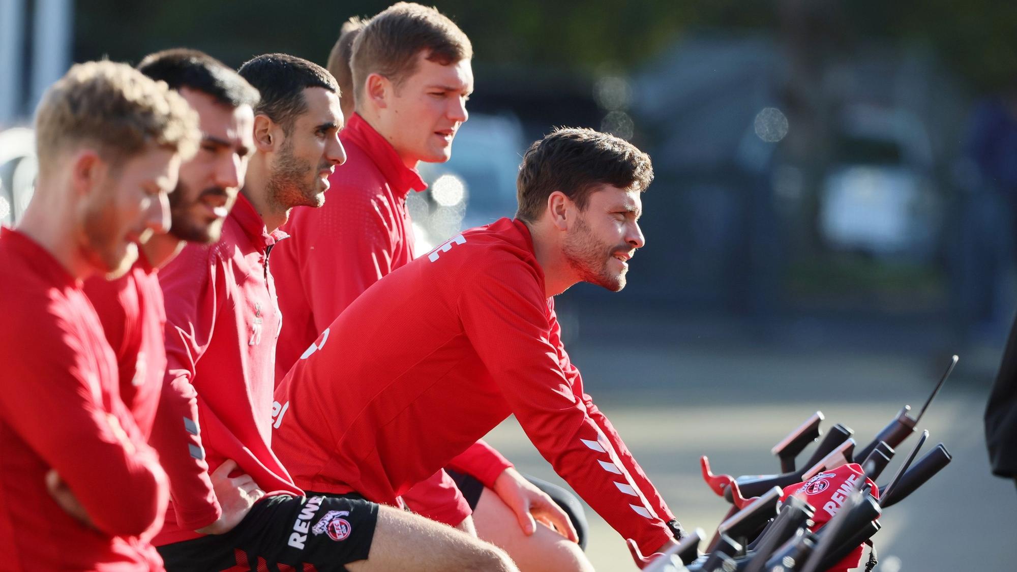 Jonas Hector fährt am Geißbockheim Fahrrad.