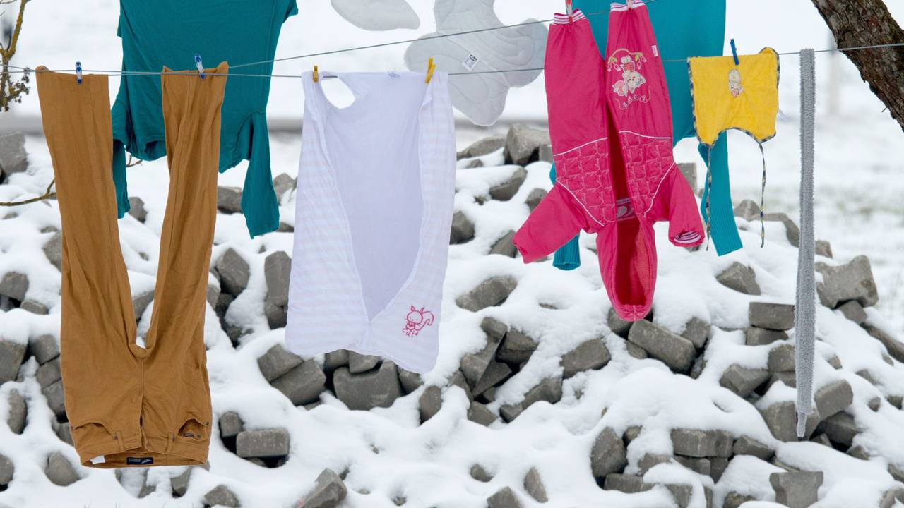 Kleidung hängt bei frostigen Temperaturen auf einer Wäscheleine.