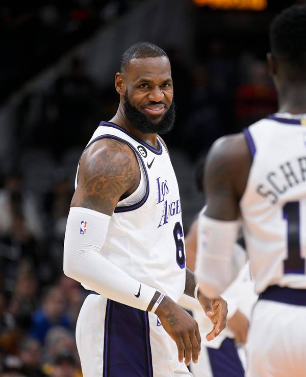 LeBron James lächelt im NBA-Spiel in San Antonio Teamkollege Dennis Schröder von den Los Angeles Lakers an.