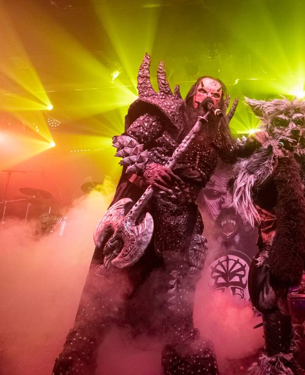 Der Sänger von Lordi und ein Mann im Werwolf-Kostüm stehen mit Mikrofonen auf der Bühne und singen.