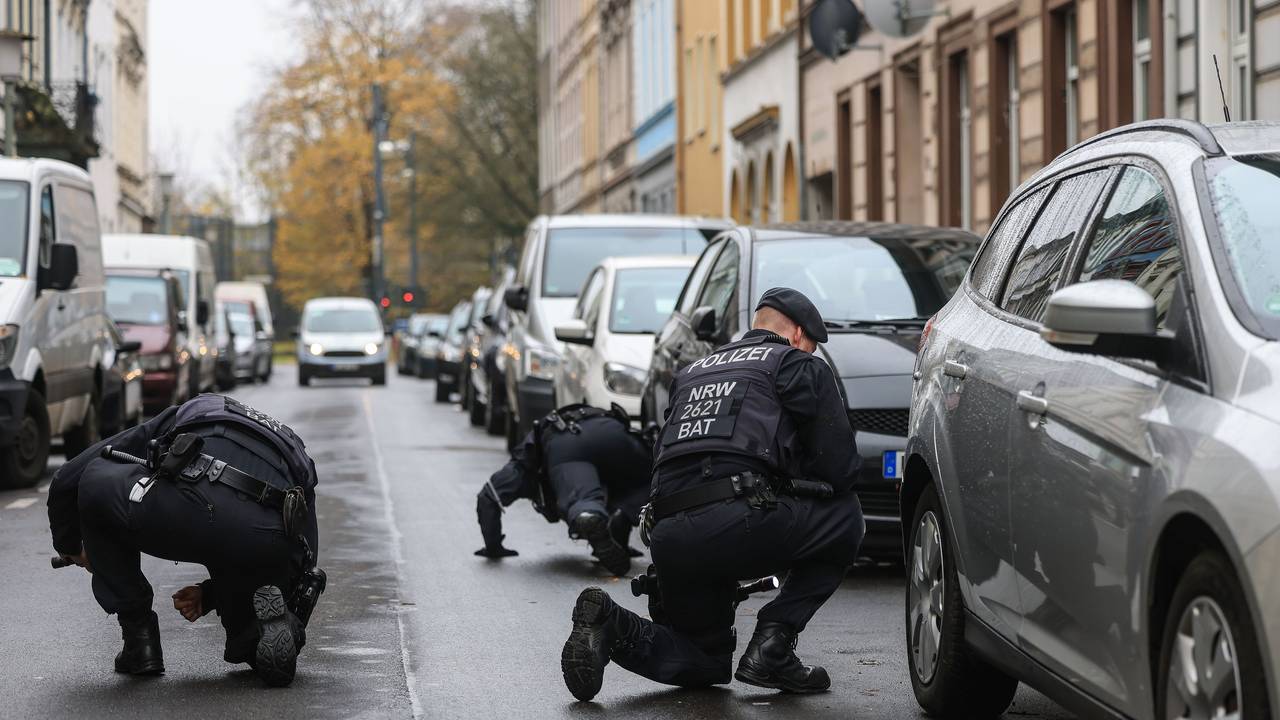 Polizisten suchen in der Nähe eines Tatortes nach Spuren.