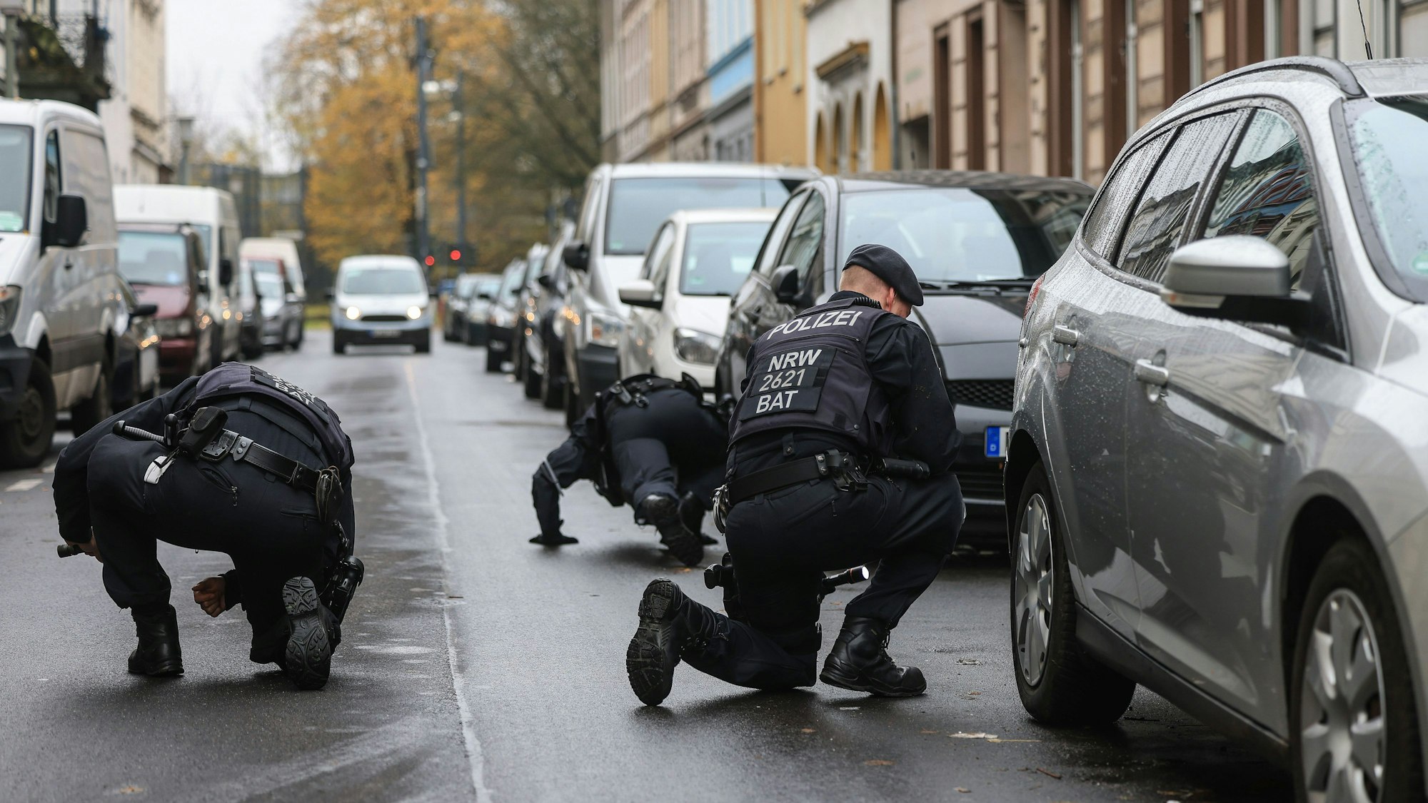 Polizisten suchen in der Nähe eines Tatortes nach Spuren.