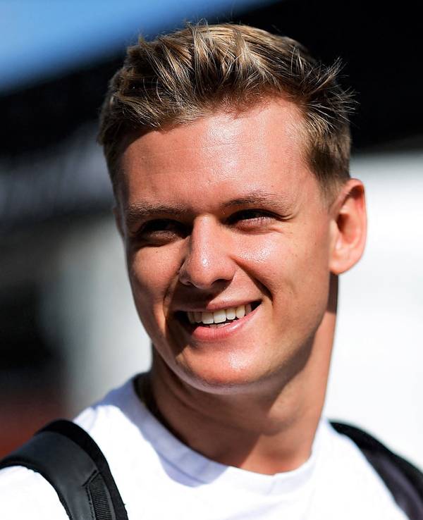 Mick Schumacher geht am Rande des USA-Rennens der Formel 1 in Austin lächelnd durch das Fahrerlager