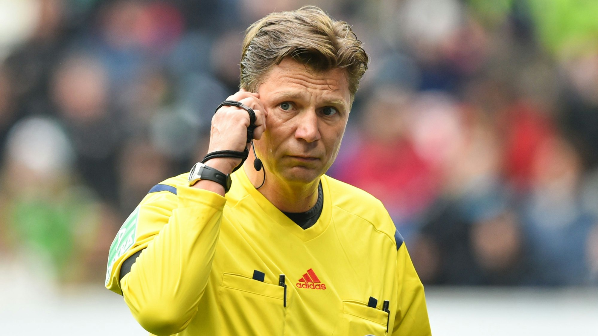 Der damalige Schiedsrichter Thorsten Kinhöfer fasst sich in der Rhein-Neckar-Arena beim Spiel TSG 1899 Hoffenheim gegen Borussia Mönchengladbach ans Ohr.