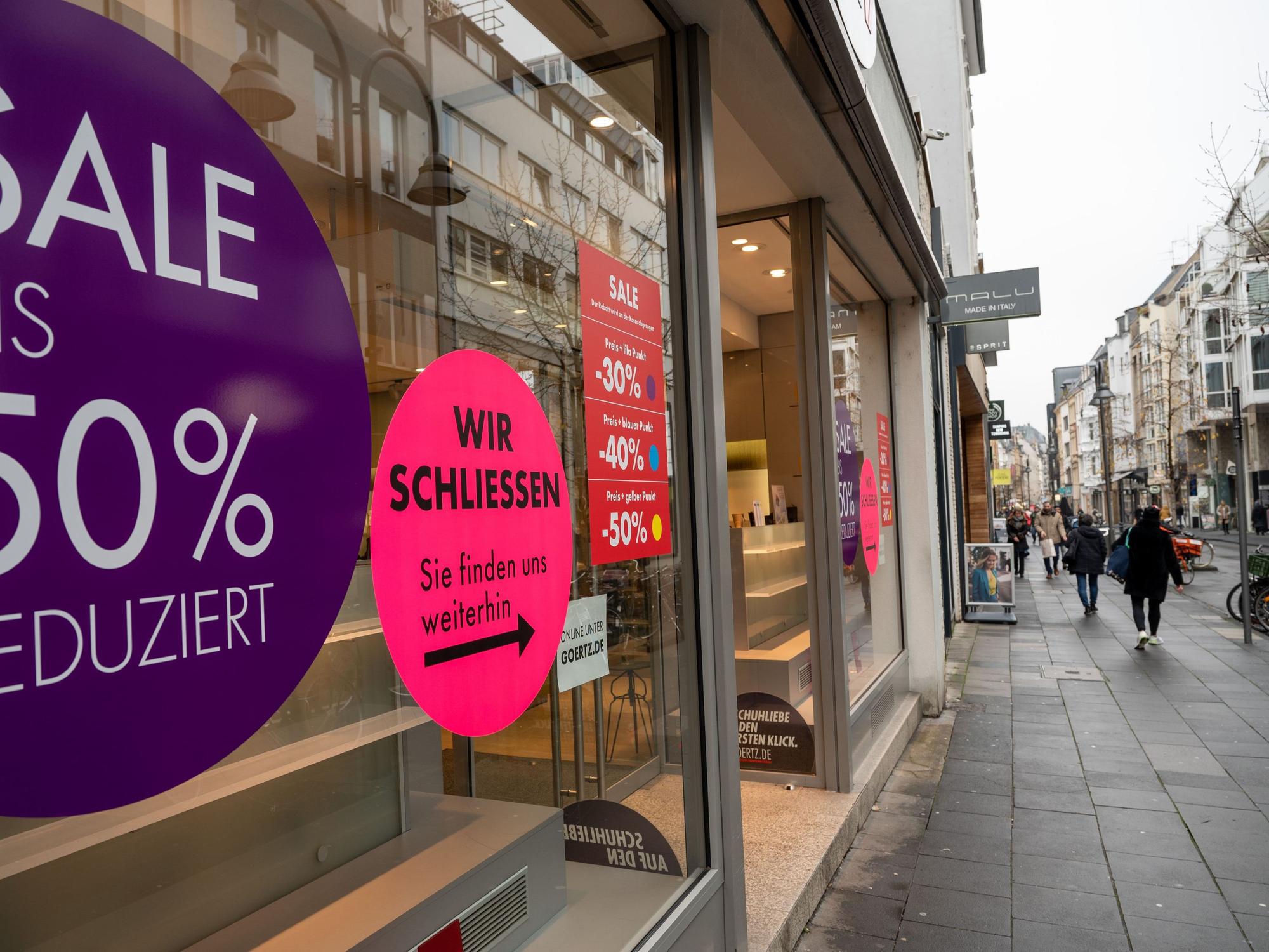 Die Filiale von Görtz auf der Kölner Ehrenstraße von außen. Zu sehen sind unter anderem Aufkleber, auf denen die Schließung des Ladens angekündigt wird.