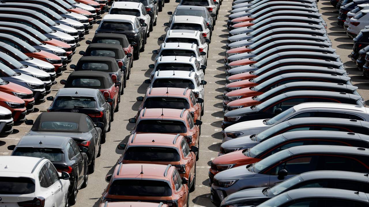Das Symbolfoto zeigt verschiedenfarbige Mietwagen, die auf einem großen Parkplatz aufgereiht sind.