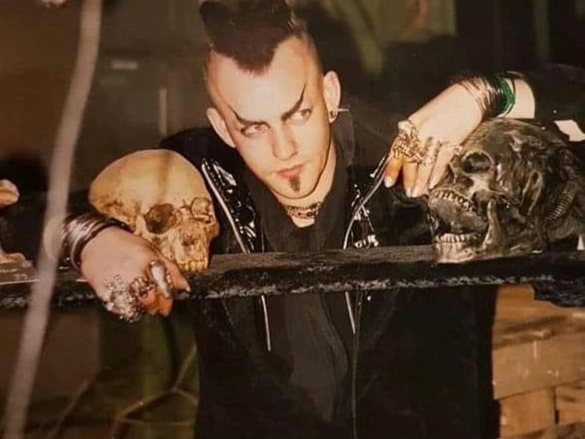 Michael Kämpfer lehnt sich an einen Balken mit Totenköpfen.