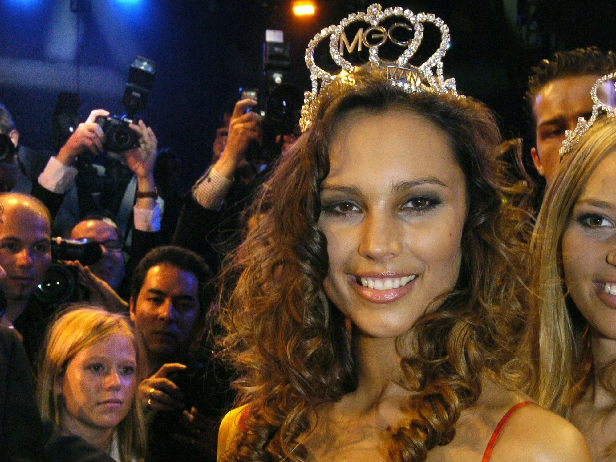 Die Miss Germany 2004 lächelt nach ihrem Sieg in die Kamera. Sie trägt eine Krone.