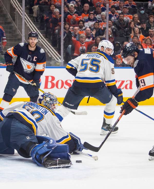 Edmonton Oilers' Leon Draisaitl (29) scores what would be ruled a disallowed goal on St. Louis Blues goalie Jordan Binnington (50) during overtime of an NHL hockey game, Thursday, Dec. 15, 2022 in Edmonton Alberta. (Amber Bracken/The Canadian Press via AP)