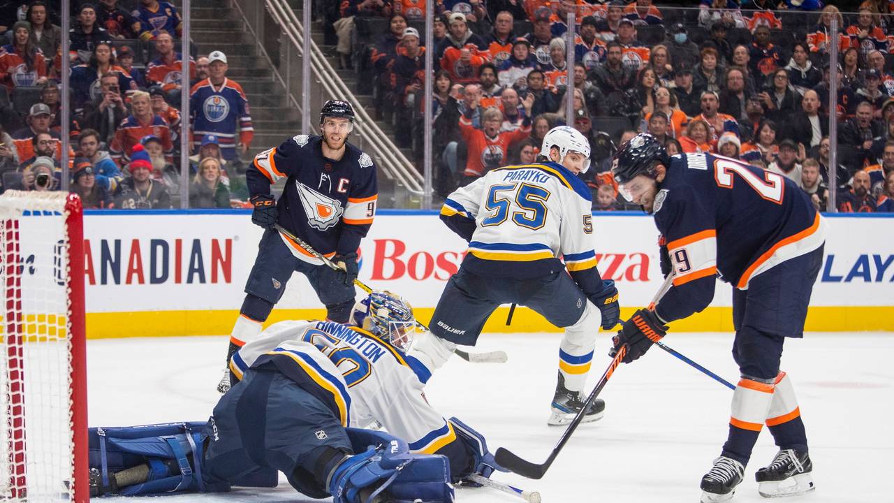Edmonton Oilers' Leon Draisaitl (29) scores what would be ruled a disallowed goal on St. Louis Blues goalie Jordan Binnington (50) during overtime of an NHL hockey game, Thursday, Dec. 15, 2022 in Edmonton Alberta. (Amber Bracken/The Canadian Press via AP)