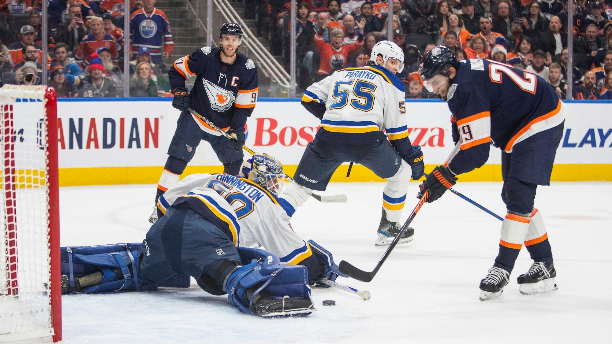 Edmonton Oilers' Leon Draisaitl (29) scores what would be ruled a disallowed goal on St. Louis Blues goalie Jordan Binnington (50) during overtime of an NHL hockey game, Thursday, Dec. 15, 2022 in Edmonton Alberta. (Amber Bracken/The Canadian Press via AP)