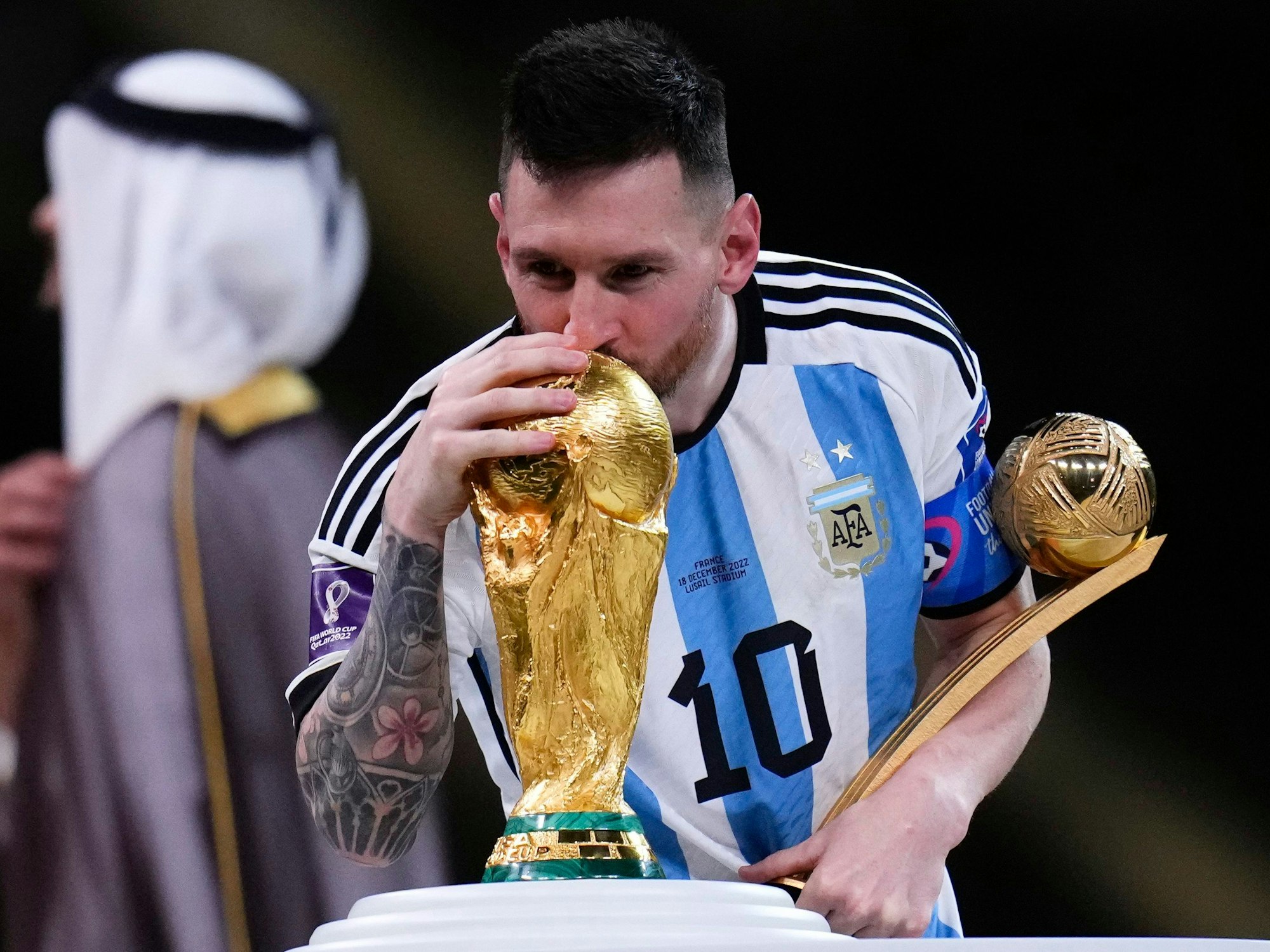 Lionel Messi küsst den WM-Pokal.