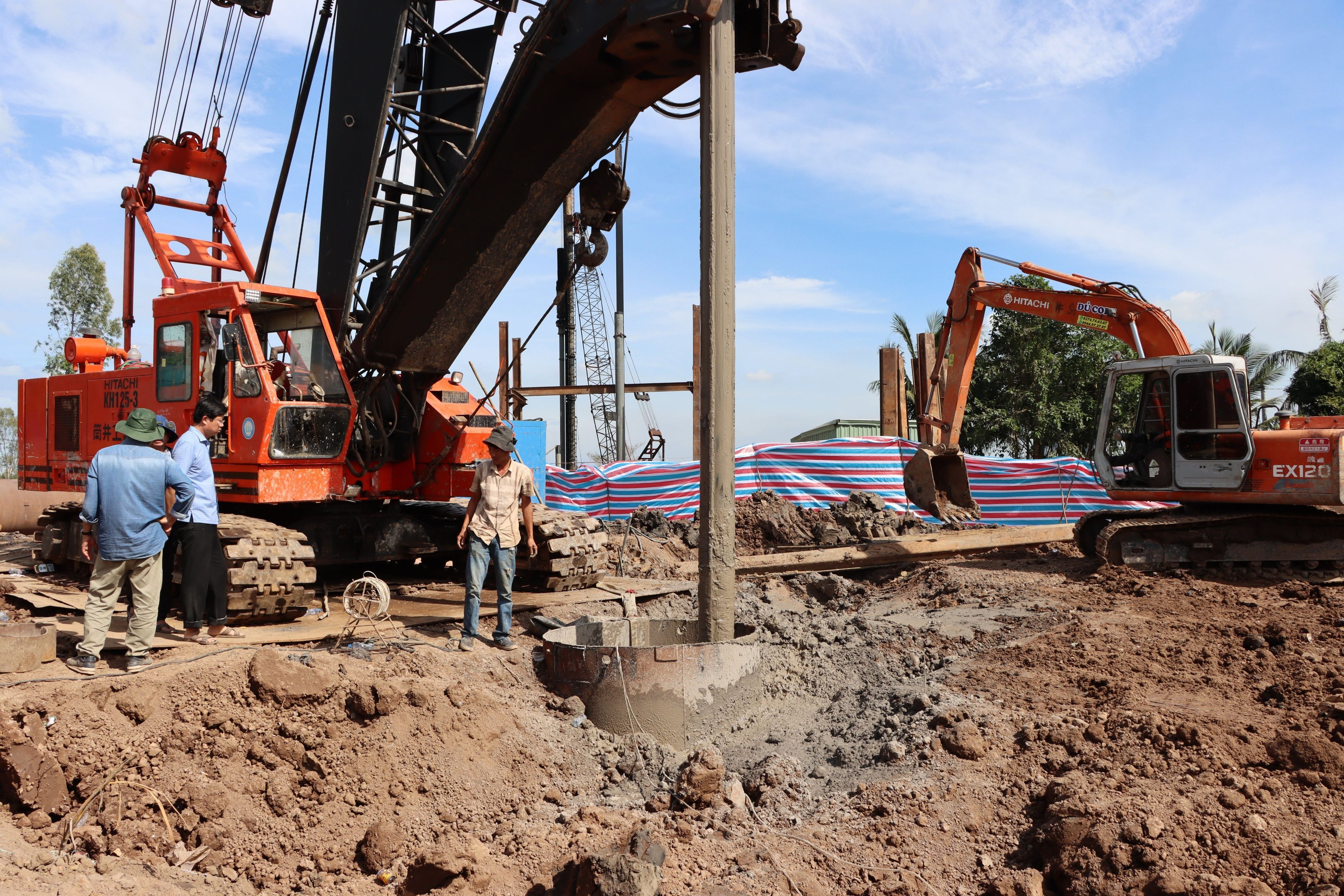 Rettungskräfte stehen an einem Rohr auf einer Baustelle. Drei Tage nach dem Sturz des Jungen in ein 35 Meter tiefes Betonrohr im Südwesten von Vietnam, ist der Junge verstorben.