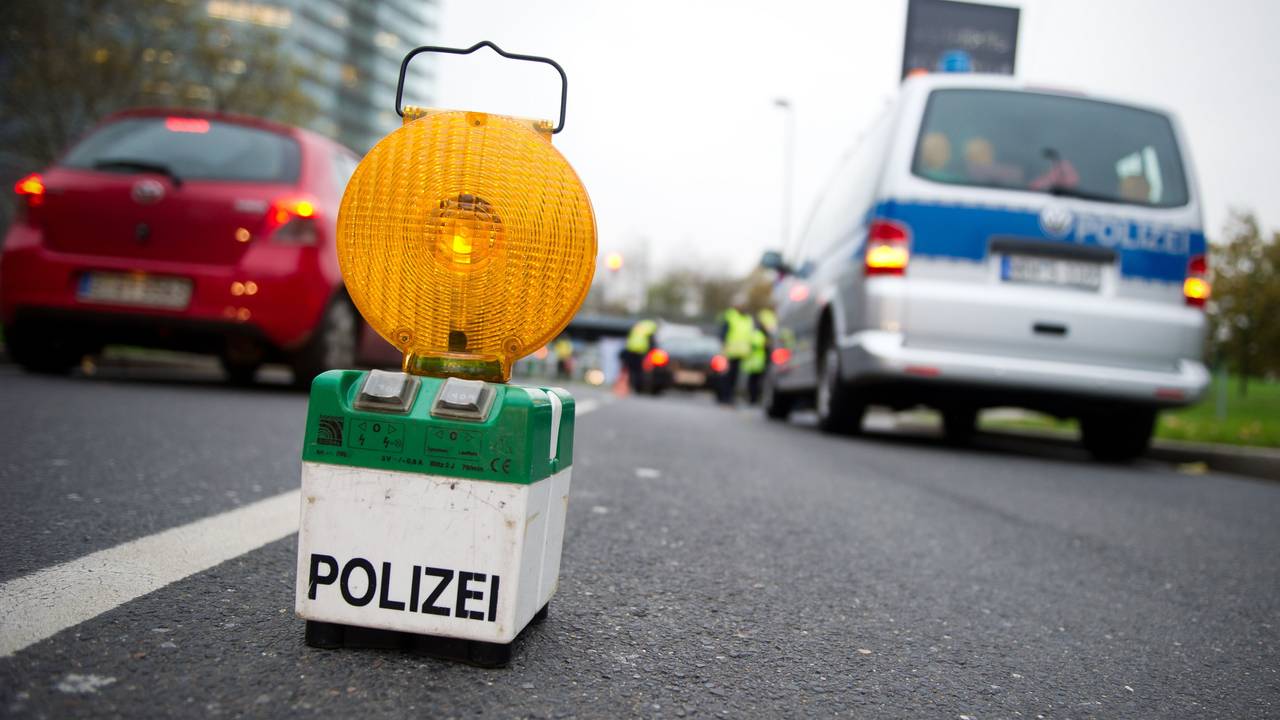 Polizeibeamte kontrollieren in Düsseldorf Fahrzeuge.