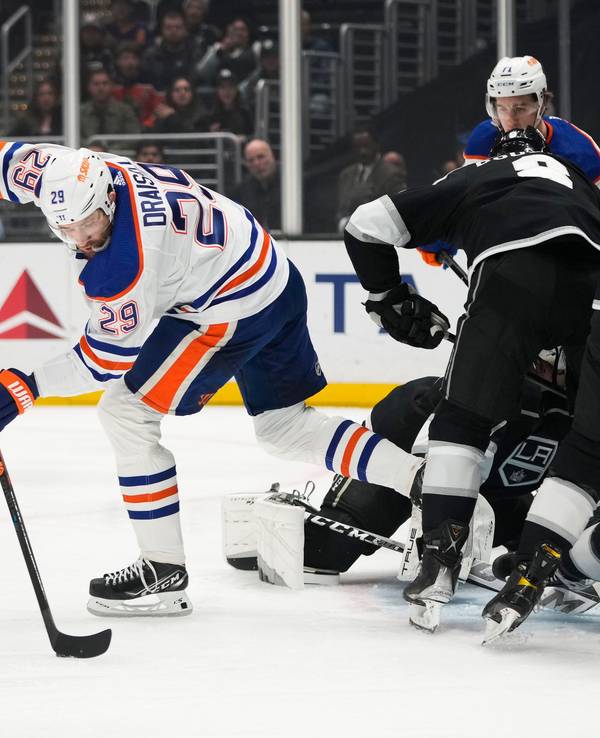 Leon Draisaitl (29) von den Edmonton Oilers bewegt den Puck, während sich die Spieler der Los Angeles Kings um das Netz herum verheddern.
