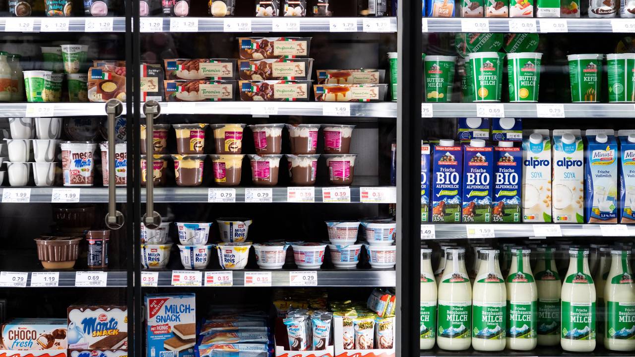 Milchprodukte von verschiedenen Herstellern stehen in einem Supermarktregal.