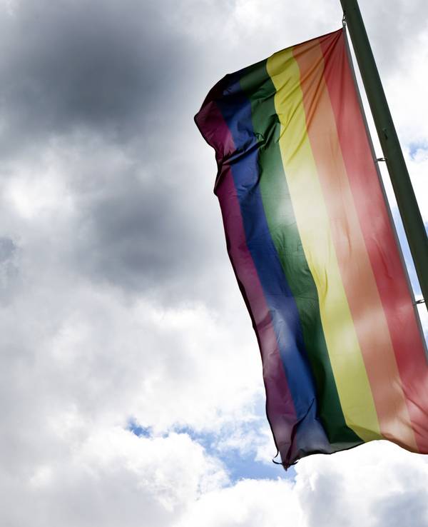 Eine Regenbogenflagge weht im Wind.