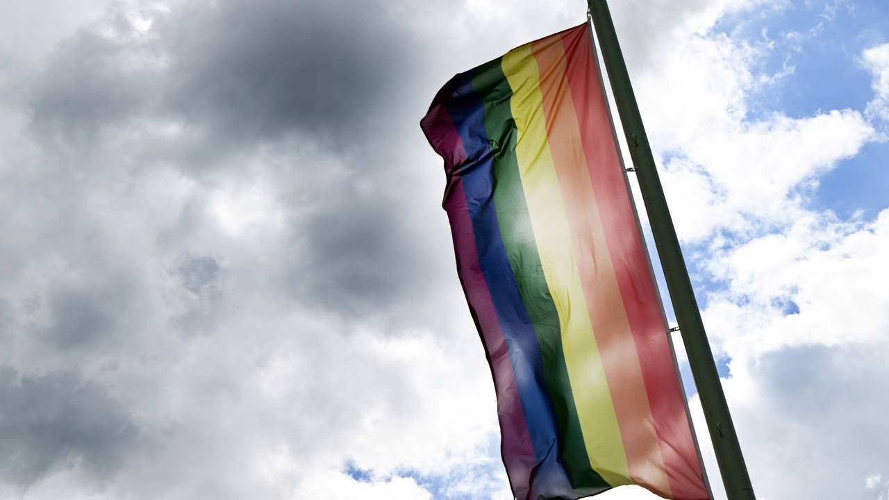 Eine Regenbogenflagge weht im Wind.