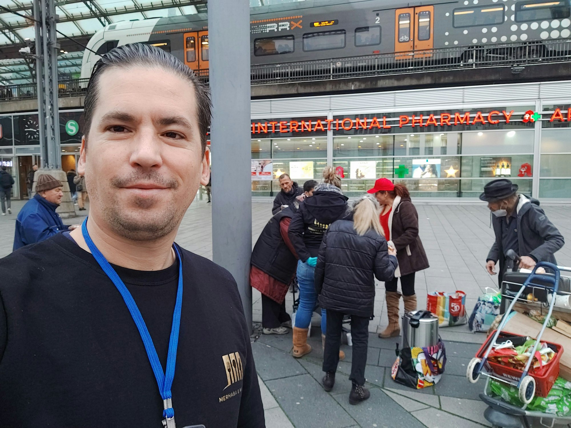 Ein Mann steht vor einer Gruppe und macht ein Selfie.