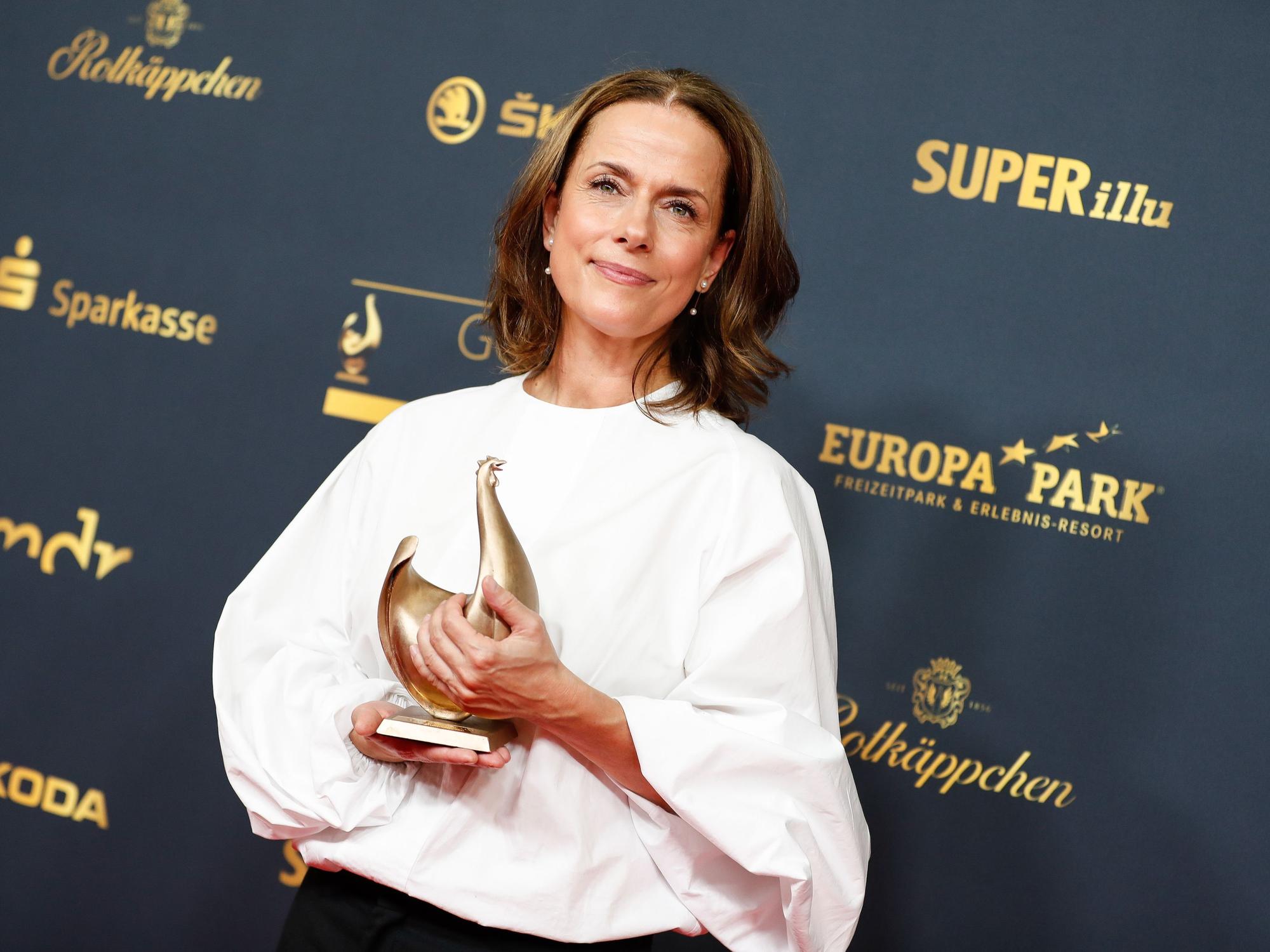 Claudia Michelsen posiert mit dem Preis „Goldene Henne“ in der Kongresshalle Leipzig.