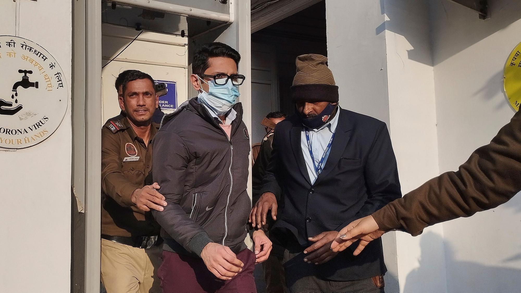 Polizisten eskortieren einen Mann, der nach einem Vorfall in einem Flugzeug von Air India vor Gericht steht.