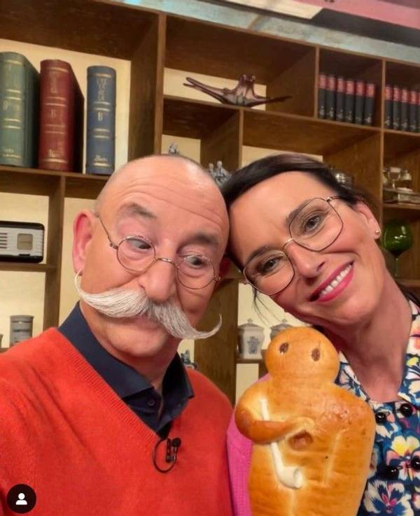 Dr. Heide Rezepa-Zabel und „Bares für Rares“-Moderator Horst Lichter lächeln mit einem Weckmann in der Hand in die Kamera.