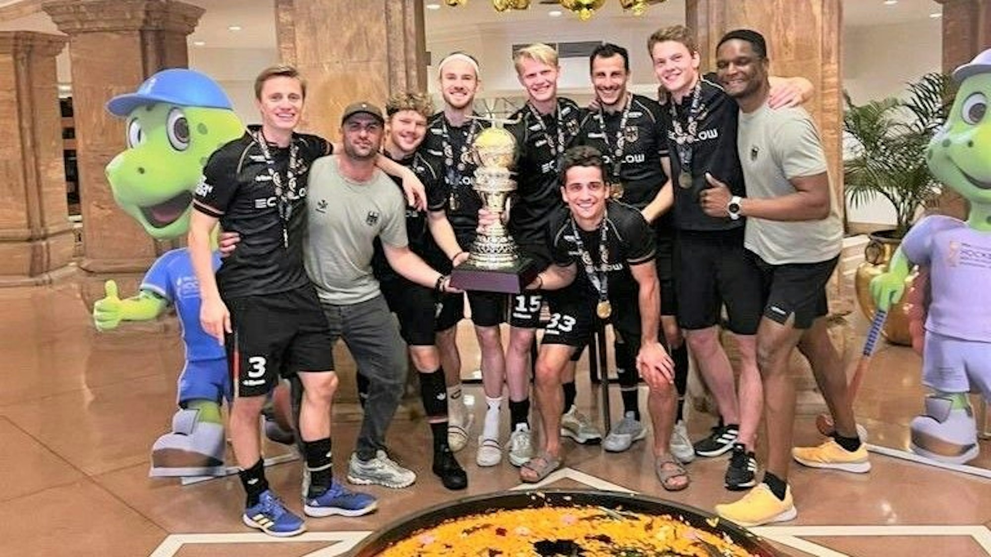Die Kölner Hockey-Weltmeister feiern mit dem WM-Pokal.