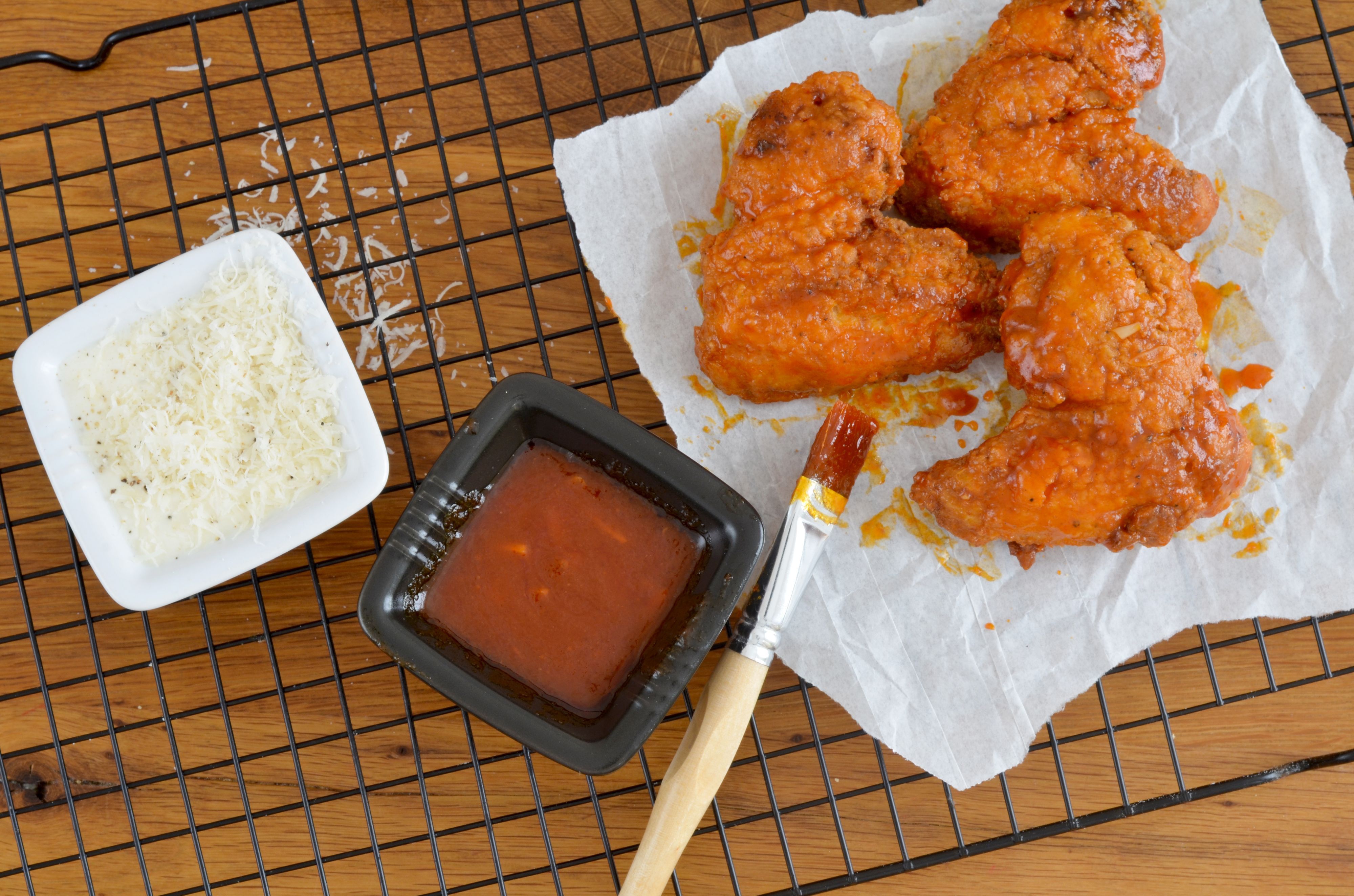 Chicken Wings, hier im März 2021 in Köln, liegen auf einem Gitter. Eine Frau im US-Staat Illinois muss sich wegen eines kuriosen Diebstahls im Wert von 1,5 Millionen US-Dollar verantworten.