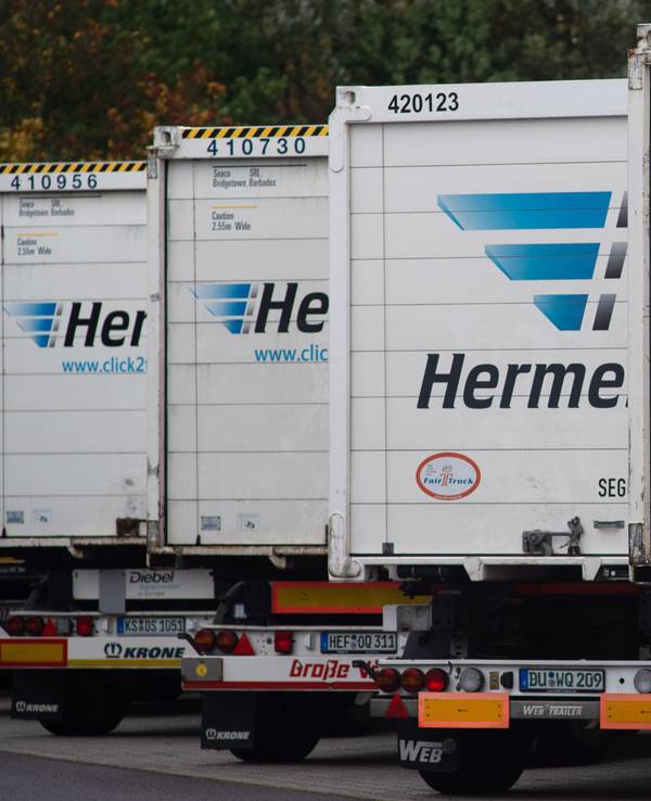 Hermes-Lastwagen stehen auf dem LKW-Parkplatz vor dem Tor des Versandzentrums des Paketdienstleisters Hermes dicht an dicht.