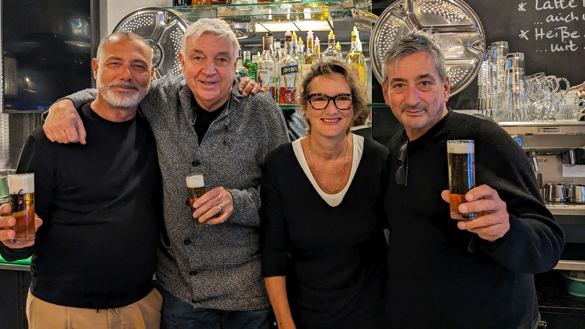 Köln: Die Café-Waschsalon-Inhaber Dirk Holzmann und Jürgen Walter. Dabei stehen die langjährigen Angestellten Miriam und Tarik El Maani